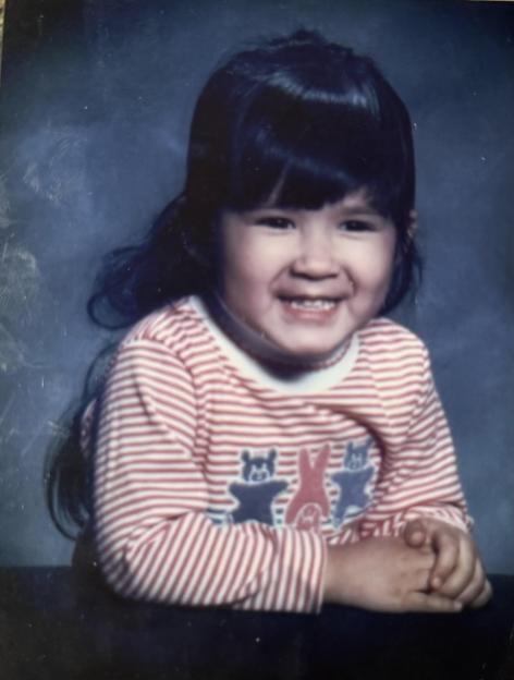 Photo of a young girl smiling.