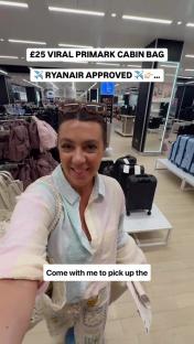 Woman in Primark buying a Ryanair-approved cabin bag.