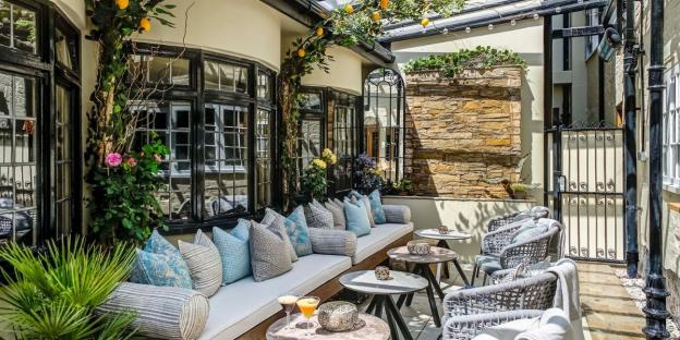 Sun-drenched patio with seating and tables.
