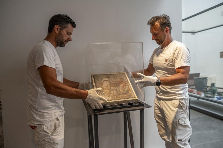 Museum staff installing an ancient Roman mosaic.