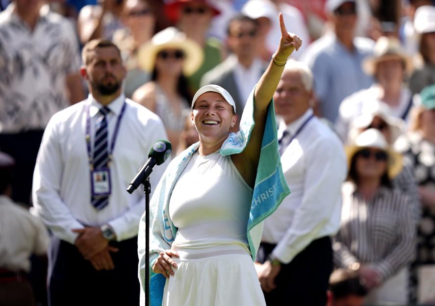 Amanda Anisimova celebrating a tennis victory at Wimbledon.