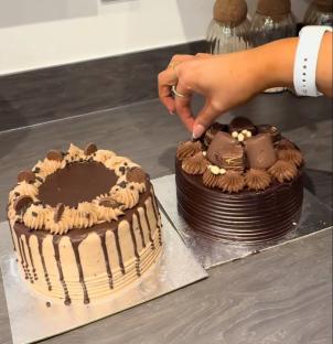 Two chocolate cakes on a kitchen counter.