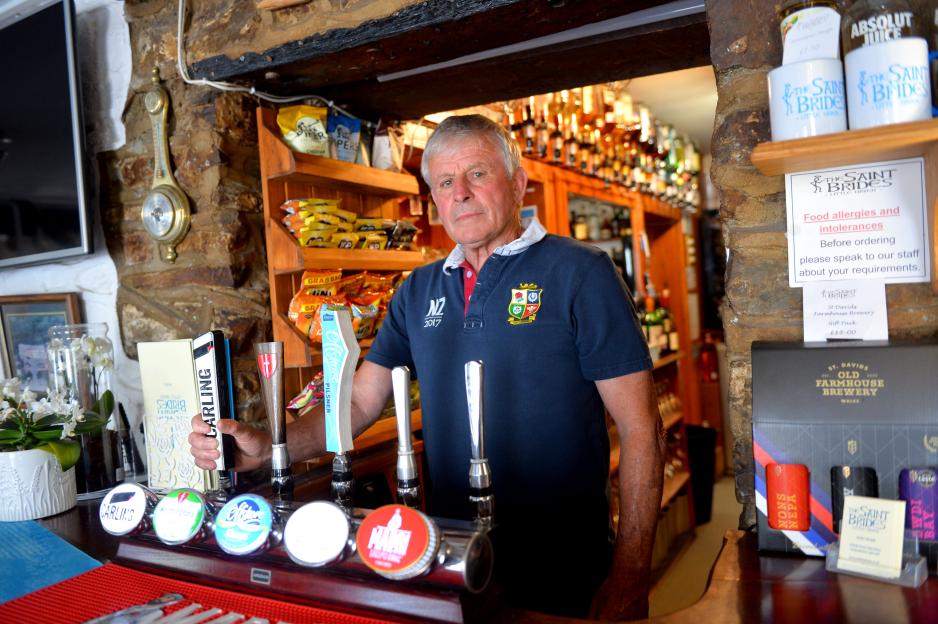 Pub landlord at the bar.