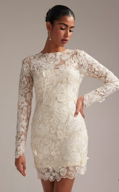 Woman in an off-white floral lace mini dress.
