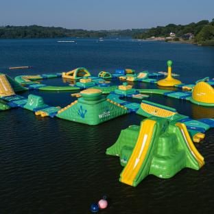 Aerial view of a Wibit aqua park on a lake.