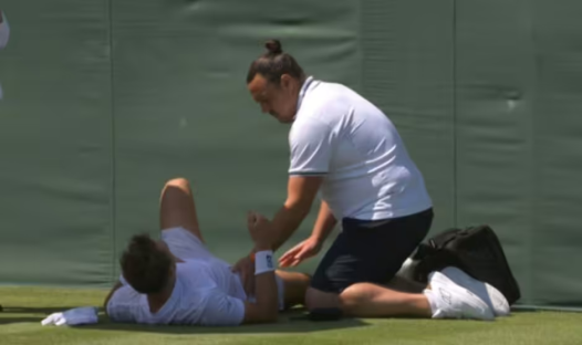 Tennis player receiving medical attention on the court.