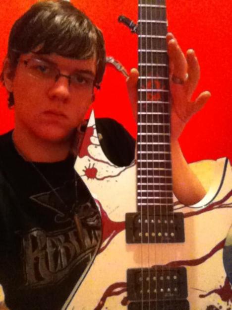 Person holding a custom-painted guitar.