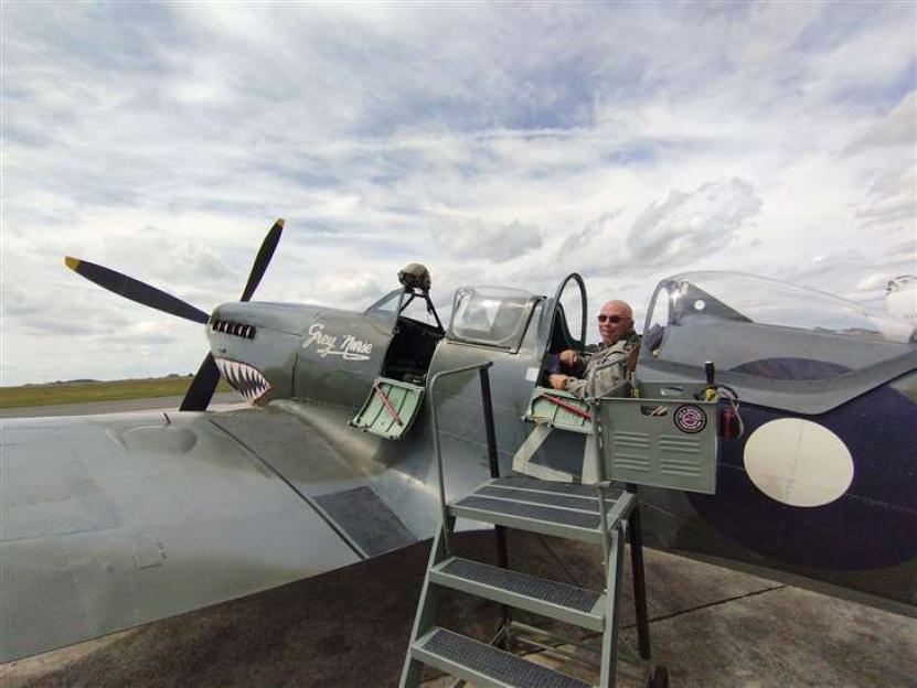 Man in Spitfire cockpit.