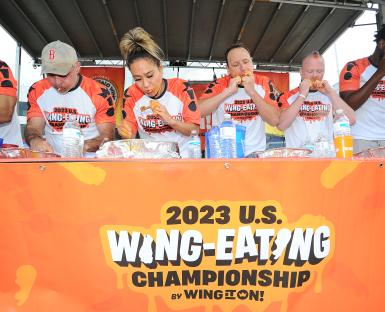 Four competitive eaters participating in the 2023 U.S. Wing-Eating Championship.