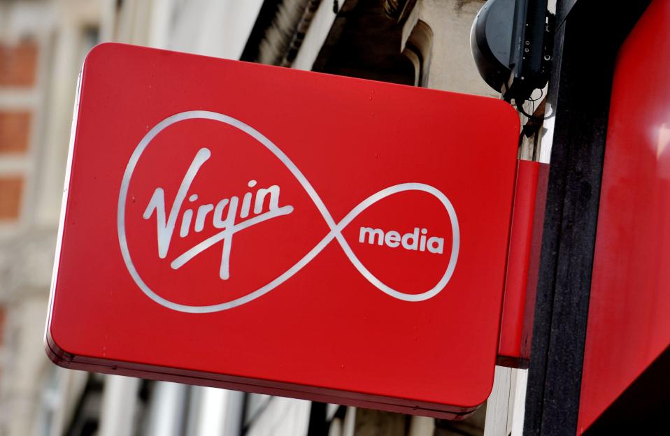 File photo dated 06/01/16 of a shop sign for Virgin media in central London. Virgin Media has cut the price of its social tariff broadband package in response to the ongoing cost-of-living crisis. Issue date: Tuesday October 11, 2022. PA Photo. The telecoms giant confirmed its Essential Broadband package, which is aimed at those people receiving Universal Credit, will drop to £12.50 a month for all new and existing customers. The package, which offers speeds of 15Mbps, is also being joined by a new speed tier, Virgin Media said, which will offer faster 50Mbps broadband for £20 a month as part of a package called Essential Broadband Plus. See PA story TECHNOLOGY VirginMedia. Photo credit should read: Nicholas.T.Ansell/PA Wire