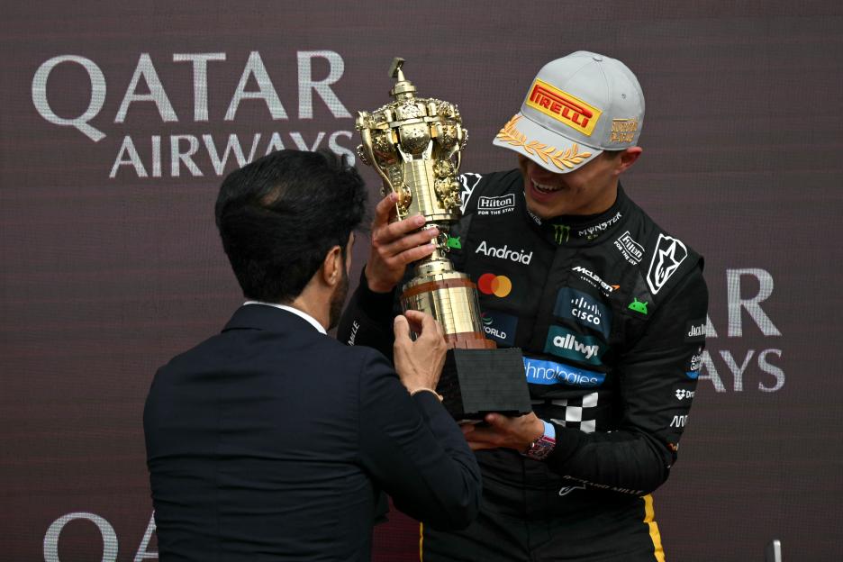 Lando Norris receiving a Lego trophy.
