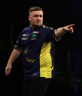 Luke Littler of England celebrating during a darts semi-final.