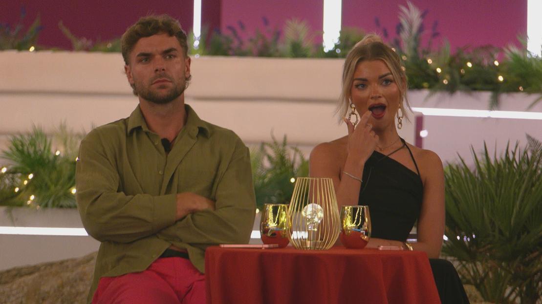 Harry and Helena from Love Island sitting at a table.