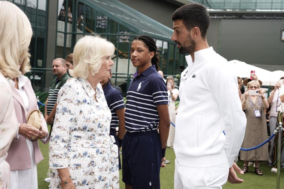 Queen Camilla speaks with Novak Djokovic at the All England Lawn Tennis and Croquet Club on day ten of the 2025 Wimbledon Championships. Picture date: Wednesday July 9, 2025. PA Photo. Photo credit should read: Jordan Pettitt/PA Wire. RESTRICTIONS: Editorial use only. No commercial use without prior written consent of the AELTC. Still image use only - no moving images to emulate broadcast. No superimposing or removal of sponsor/ad logos.
