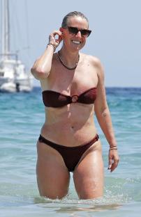 Coleen Rooney in a brown bikini in the ocean.