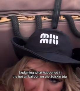 Woman in a hat explaining a hot air balloon ride.