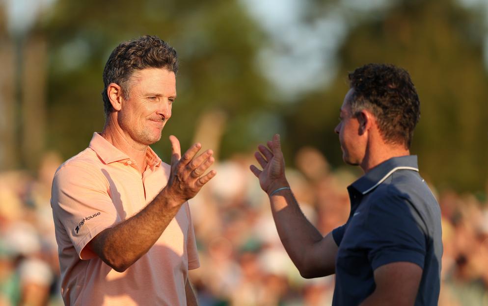 Rory McIlroy of Northern Ireland shakes hands with Justin Rose of England.