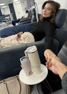 Woman receiving chemotherapy, holding hands with a loved one.