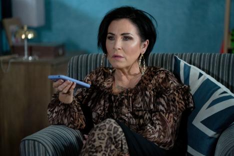 Kat Slater from EastEnders using a remote control.