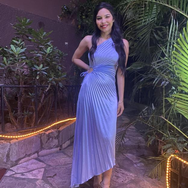 Woman in a light blue pleated dress.