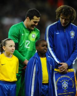 Two Brazilian soccer players with two young fans.