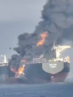 A burning oil tanker, the ABAL TIER, at sea.