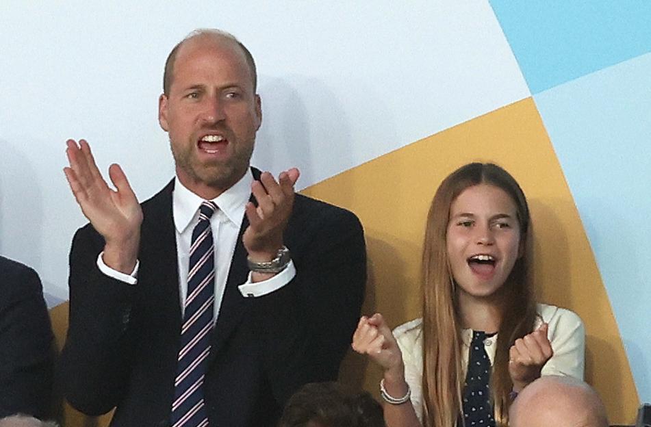 Prince William and Princess Charlotte watching a soccer match.