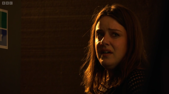 Screenshot of a young woman crying.