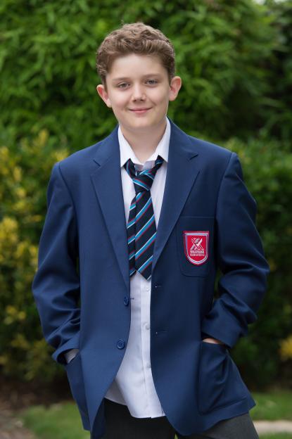 Ellis Hollins, who plays Tom Cunningham in Hollyoaks, wearing a school uniform.