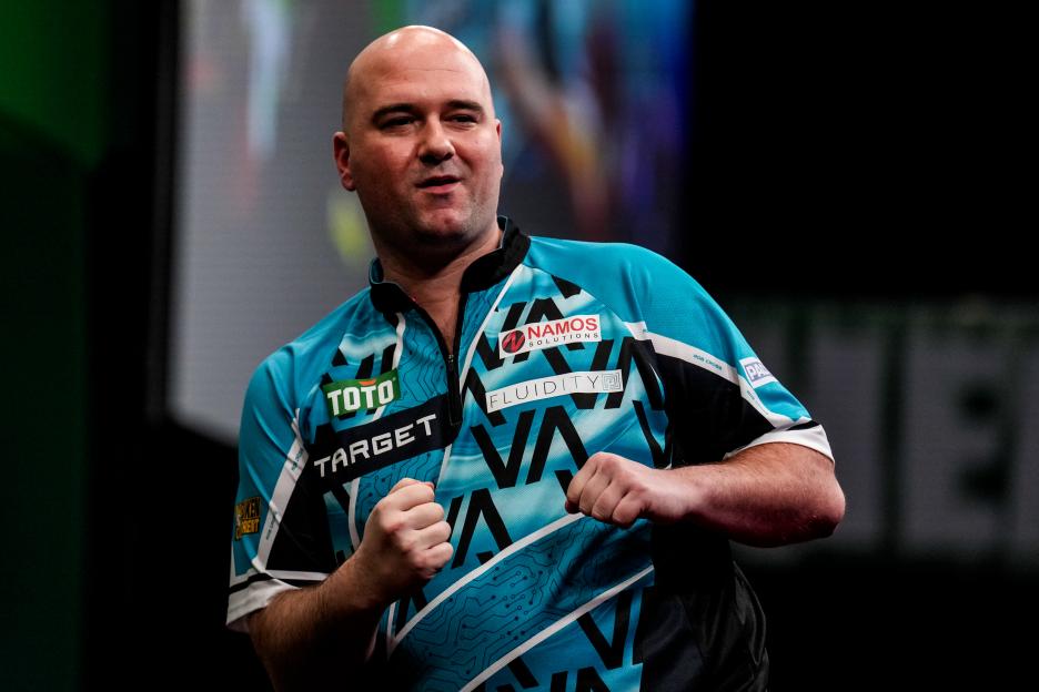 Rob Cross celebrating at a darts match.