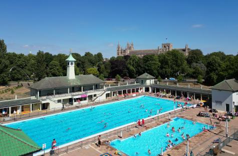 Aerial view of Peterborough Lido with many people swimming.