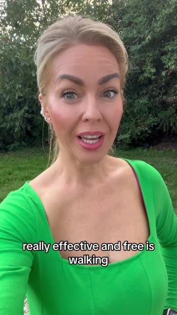Woman in green shirt recommending walking as a free and effective weight loss method.