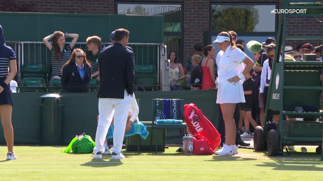 A Wimbledon tennis player is questioned by an official about her outfit.
