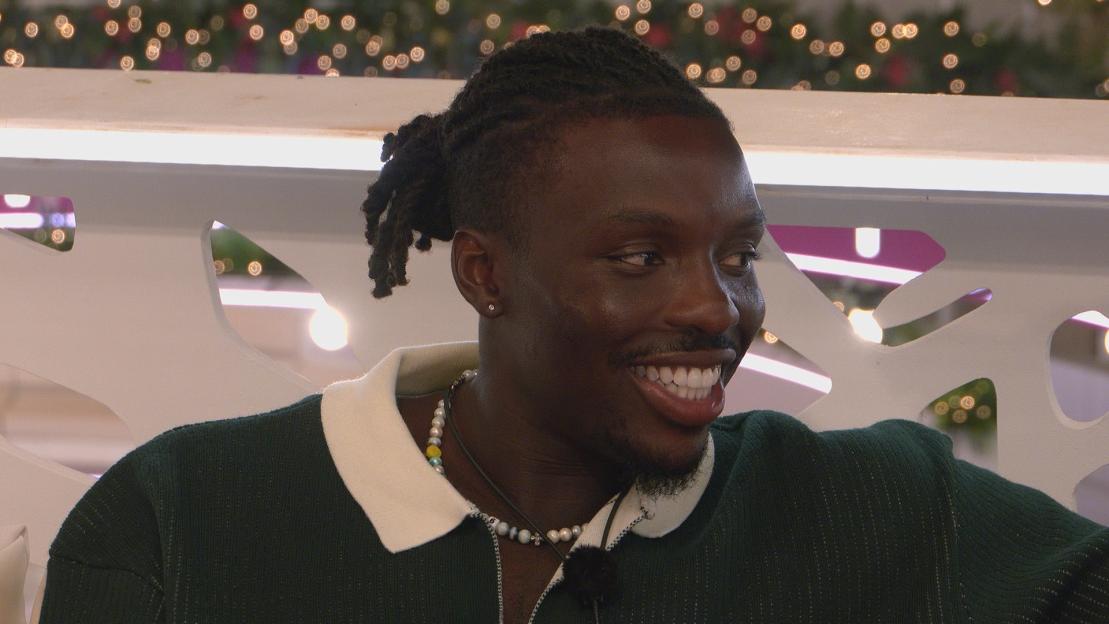Dejon from Love Island smiling.