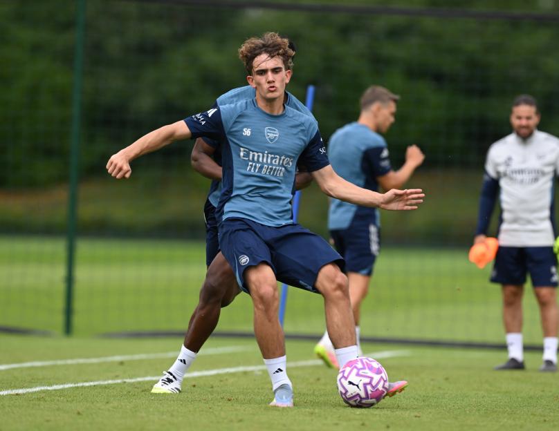 Max Downan and Martin Odegaard of Arsenal embracing during a training session.