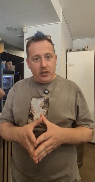 Man reviewing a cheap full English breakfast.