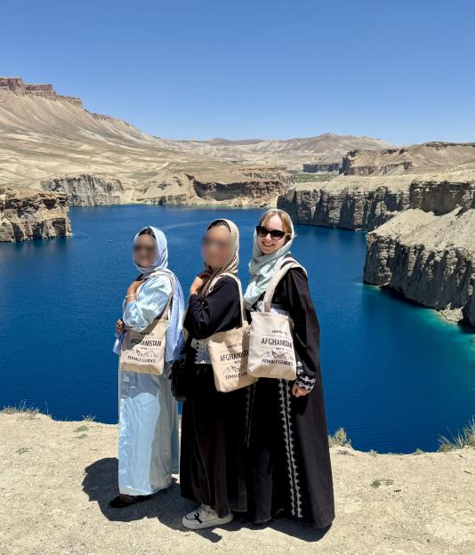 Three women tourists in Afghanistan near a lake.