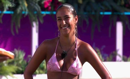 Smiling woman in pink bikini top.