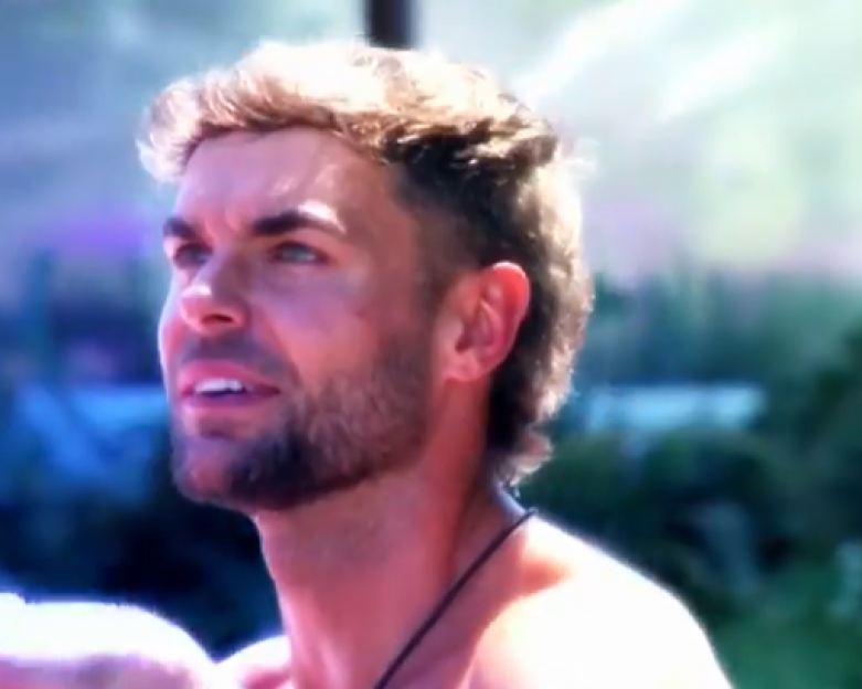 Screenshot of a man looking up.