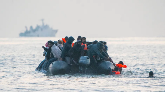 Migrants in a small boat at sea.