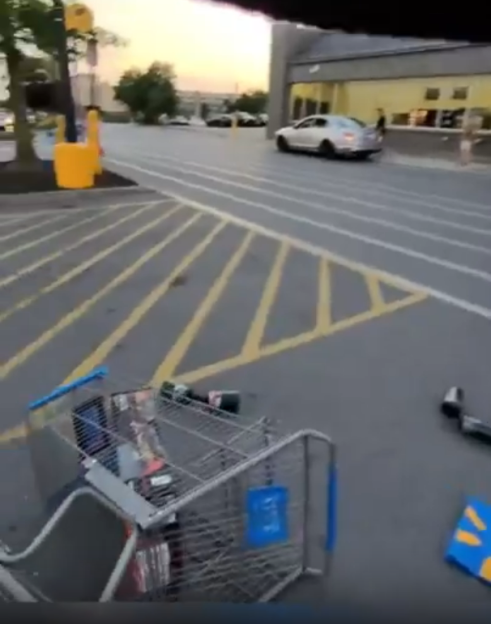 Upset shopping cart in parking lot.