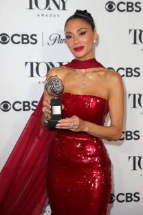 Nicole Scherzinger holding a Tony Award.