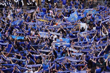 Real Oviedo players celebrating promotion with fans.