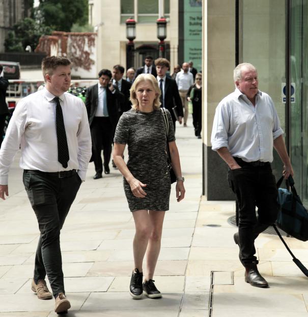 Jennifer Scott and two others walking outside a courthouse.