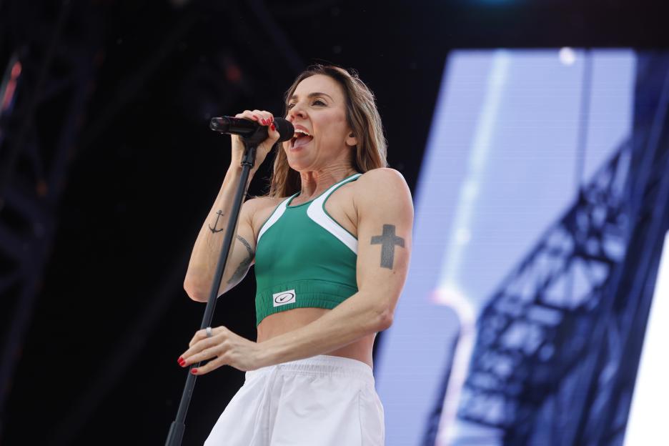 Melanie C performing on stage at a music festival.