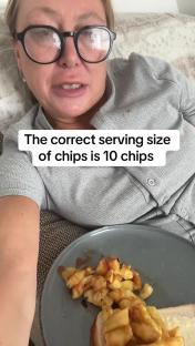 Woman holding a plate of ten chips.
