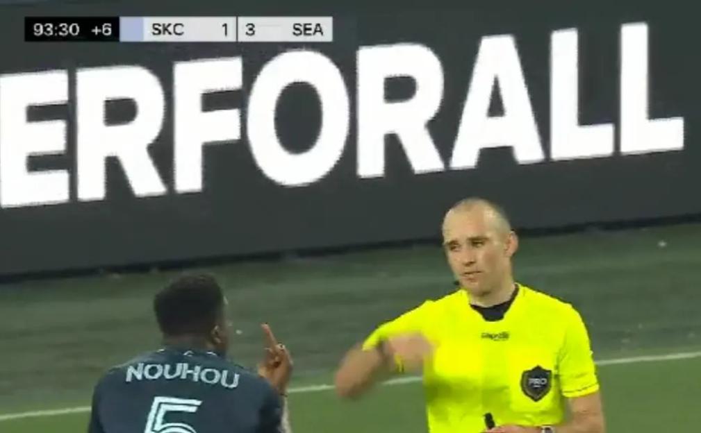 Referee showing a yellow card to a soccer player.