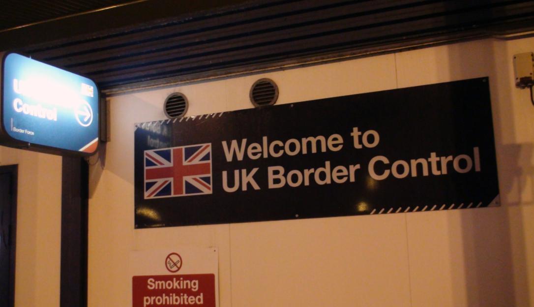 UK Border Control sign with Union Jack flag.