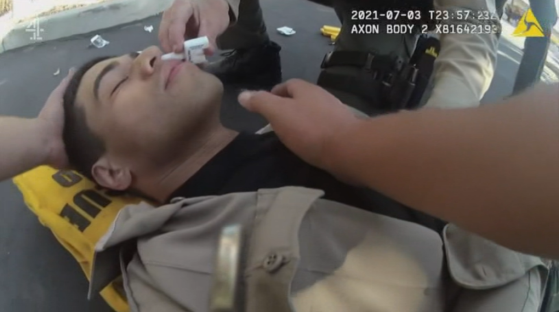 Screenshot of a person receiving medical attention.