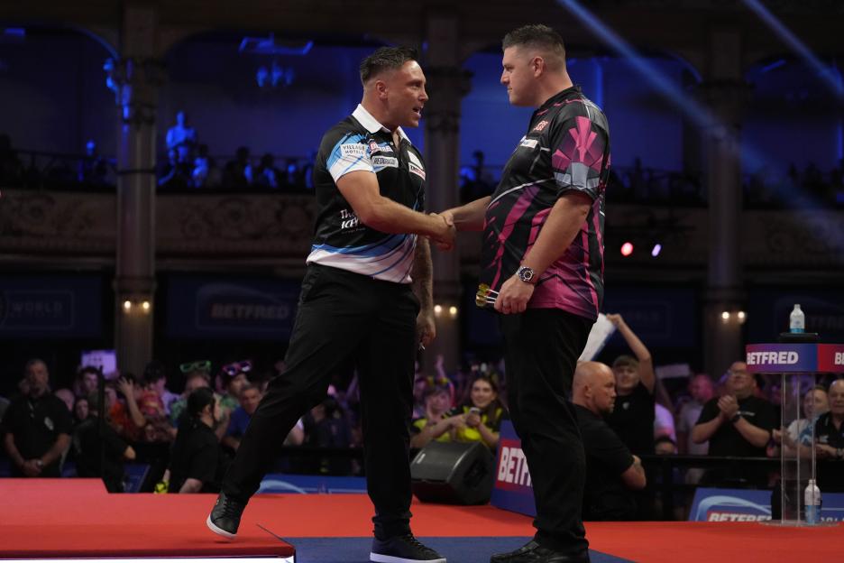 Gerwyn Price and Daryl Gurney shaking hands after a darts match.